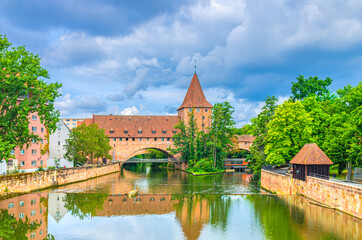 Schlayerturm Schlayer tower medieval building, Chained Suspension Bridge Kettensteg grouser, Pegnitzwehr and Pegnitz river embankment in Old town Nuremberg city center, Bavaria state, Germany