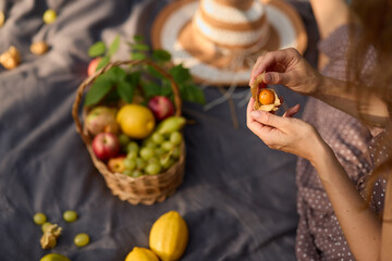 Bright summer setting with woman preparing fresh apricot snack