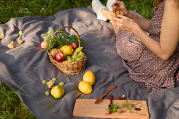 Summer picnic setup, Woman organizing colorful fruit for picnic