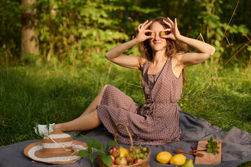 Young woman arranging farmhouse style picnic with seasonal produce
