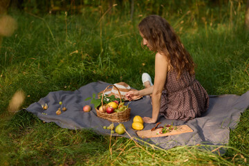 Relaxed outdoor enjoyment, Carefree lady with fruit on lush grass