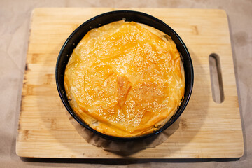 Close-up of vegan Serbian burek on board.