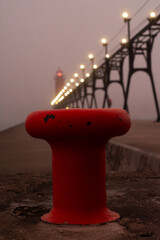 Sunrise on a foggy morning on the Grand Haven south pierhead with the inner light beacon and outer lighthouse.