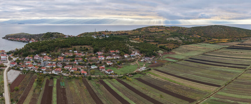 Aerial view of Lin village and autumn fields overlooking Lake Ohrid under soft morning light.