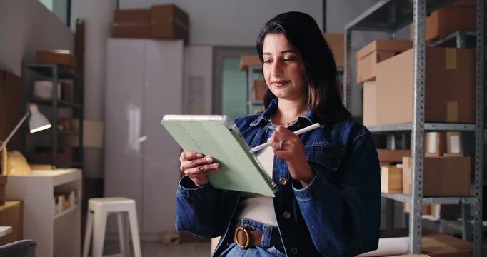Ecommerce, checklist or Indian woman in office with tablet, inventory or export management in supply chain. Logistics, boxes or supplier in agency with tech, stock or cargo control in distribution.
