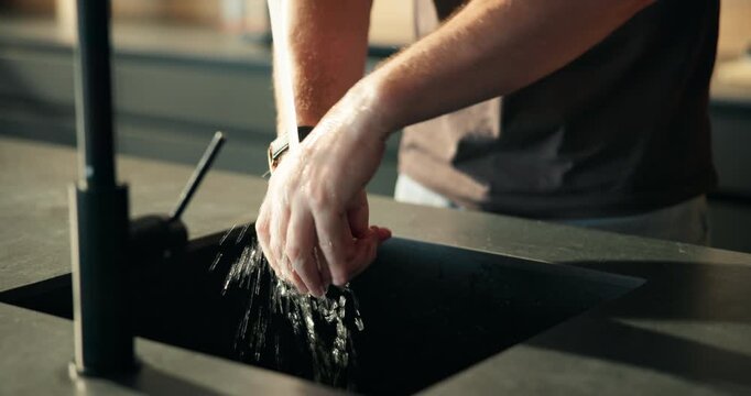 Hygiene, man and washing hands at tap in kitchen for dirt removal, germ prevention and sanitation. Wellness, person and cleaning skin with water in home for bacteria safety, cleanliness and self care