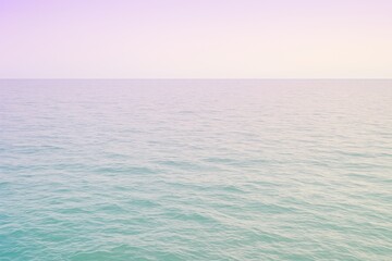 Obraz premium Serene pastel ocean horizon with gentle waves creating a calming, ethereal backdrop for relaxation and tranquility