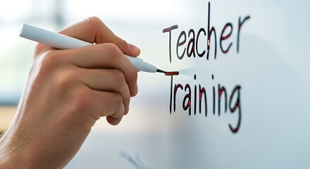 Hand writing "Teacher Training" on a whiteboard with a marker