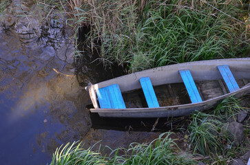 old boat in the reeds near the shore, top view