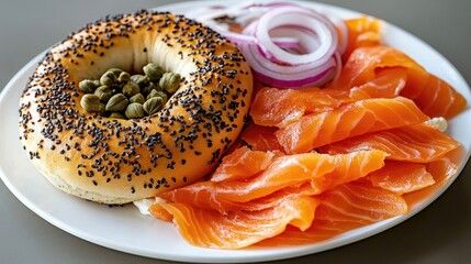Bagel topped with cream cheese, smoked salmon, capers, and red onion presented on a white plate with fresh greens