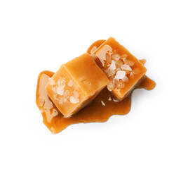 Tasty candies with salt and caramel sauce isolated on white, top view