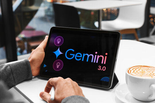 Person using gemini ai technology on tablet with coffee