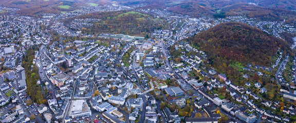 An aerial panorama view above the old town of the city Siegen on an early summer morning in Germany