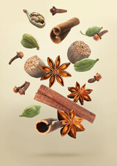 Christmas spices falling on dark beige background