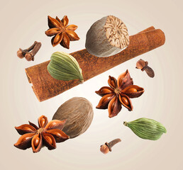 Christmas spices falling on dark beige background