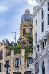 A decorative historic building in Madrid rises with curved lines, balconies, and detailed architectural features, creating a classic urban scene suited to many views