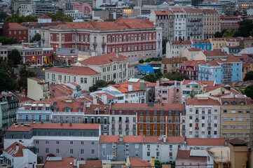 Buildings and rooftops of Lisbon, Portugal from Miradouro da Senhora do Monte in late afternoon light.