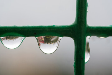 Close up of water drop on the rope reflecting cityscape, soft focus