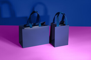 Blue paper glossy shopping bags mockup with blue handles	
