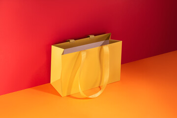 Yellow paper glossy shopping bag mockup with yellow handles	
