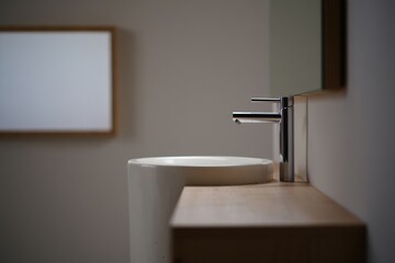Close-up of a minimalist bathroom with a freestanding sink dominating the scene