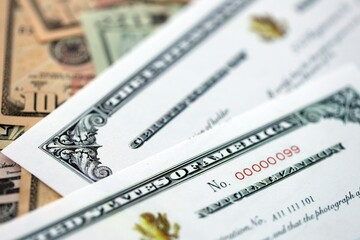 US Certificate of Naturalization on big amount of money bills close up