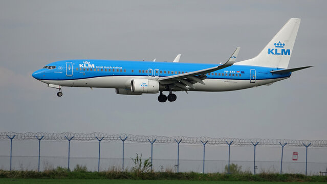 KLM Dutch airline plane lands at Prague airport on a cloudy day