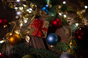 Golden Christmas Gift Box with Baubles and Festive Decorations