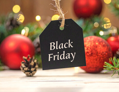 Black friday sale tag with festive christmas ornaments and pine cones
