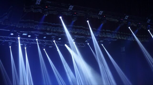 multi-colored beams of stage lighting during a concert