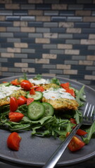 Zucchini Fritters with Tzatziki, Cucumbers, Cherry Tomatoes, and Arugula