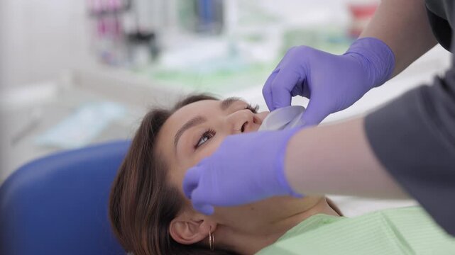 Dentist Asian female client has a silicone expander placed before dental examination.