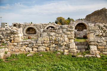 Ruins of an ancient city with stone arches on a clear sunny day, Chersonesos. Sights of Russia. Architecture of World tourism.
