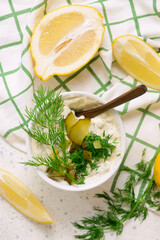 Tartar sauce with pickled cucumbers and dill in a bowl.style hugge