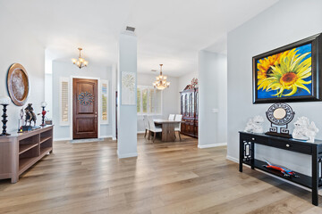 Fototapeta premium A living room with hardwood floors and a sunflower painting