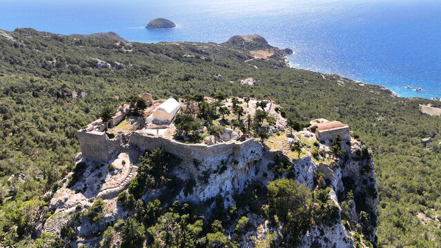 Aerial drone photo of 15th-century Castle of Monolithos built on a cliff with picturesque views of the Aegean sea, Rhodes island, Dodecanese, Greece