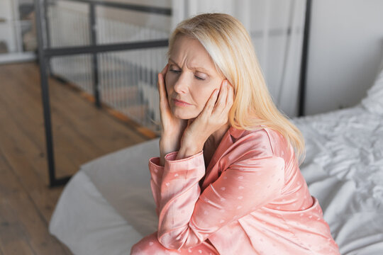 Headache, anxiety and mature woman at home with problem, mistake or mental health crisis. Migraine, stress and female worry, fear or fail, depression and brain fog or vertigo