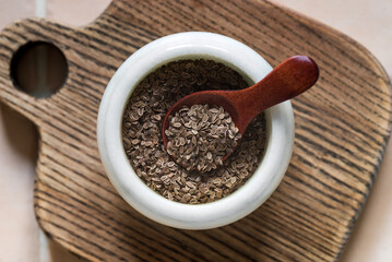 Dill seeds in a white bowl.