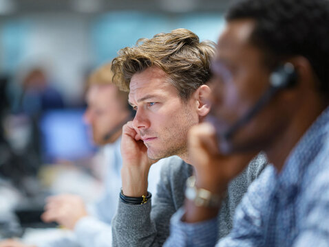 Diverse customer support team working in an office environment. Focused on solving problems. Ideal for illustrating call center, support, or professional teamwork concepts.