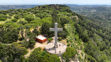 Aerial drone photo of iconic Monastery and giant Cross of Filerimos, built uphill in ruins of ancient village of Ialysos, Rhodes island, Dodecanese, Greece