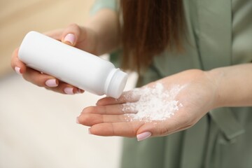 Woman using talcum powder as dry shampoo at home, closeup