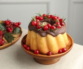Tasty Christmas cake with cranberries on table, closeup