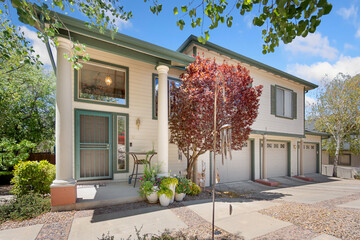 A large white house standing proudly with a tree right in front of it