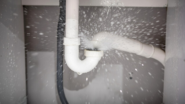 Water pipe bursting and spraying water causing a plumbing emergency