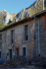 old house with firewood outside
