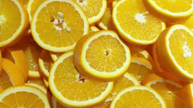 Fresh juicy orange slices, slices Of citrus tropical fruits. Background of oranges sliced circles. Orange fruit pattern. 