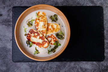 Creamy Cheese Soup, Garnished with Herbs and Melted Cheese