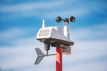 Modern weather station collecting meteorological data and providing accurate forecasts under a clear blue sky