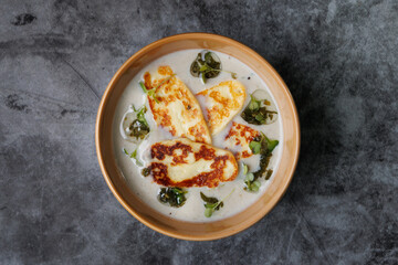 Creamy Cheese Soup, Garnished with Herbs and Melted Cheese