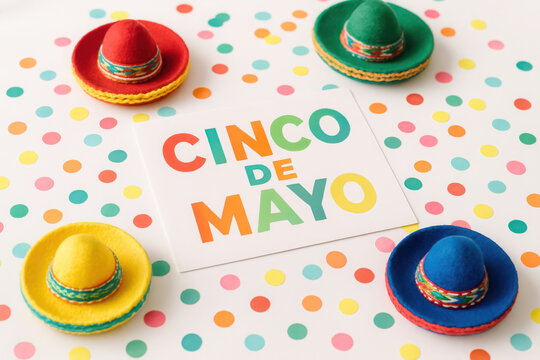 Colorful cinco de mayo celebration with mini sombreros and festive confetti background